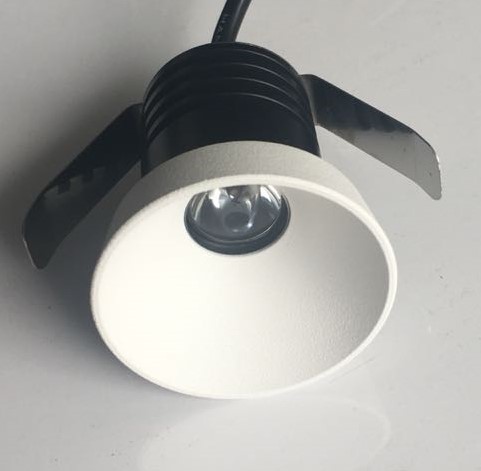 Architectural mini LED downlight highlighting retail display shelving